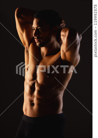 Thinking, fitness and stretching in studio with man, exercise and confidence for results. Bodybuilder, wellness and stomach for training, muscles and pride or commitment to sport by black background Thinking, fitness and stretching in studio with man, exercise and confidence for results. Bodybuilder, wellness and stomach for training, muscles and pride or commitment to sport by black background 119992878