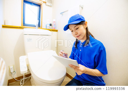 Female staff inspecting the toilet Female staff inspecting the toilet 119993336