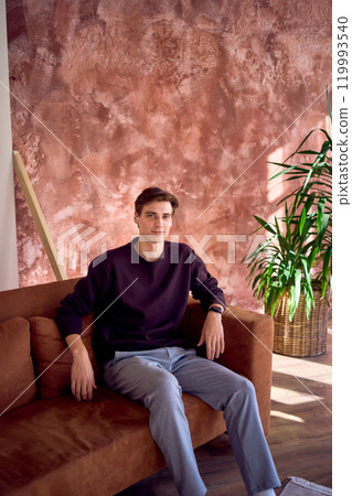 portrait of an attractive young 20 year old man with dark hair and blue eyes, studio photo shoot portrait of an attractive young 20 year old man with dark hair and blue eyes, studio photo shoot 119993540