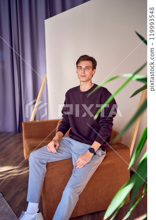 portrait of an attractive young 20 year old man with dark hair and blue eyes, studio photo shoot portrait of an attractive young 20 year old man with dark hair and blue eyes, studio photo shoot 119993548
