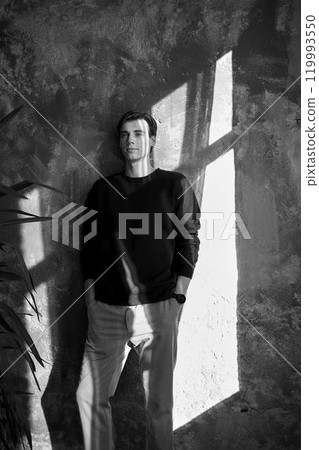 portrait of an attractive young 20 year old man with dark hair and blue eyes, studio photo shoot portrait of an attractive young 20 year old man with dark hair and blue eyes, studio photo shoot 119993550