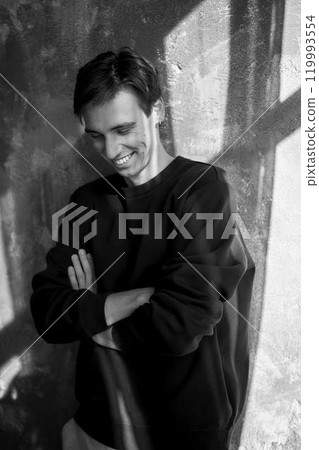 portrait of an attractive young 20 year old man with dark hair and blue eyes, studio photo shoot portrait of an attractive young 20 year old man with dark hair and blue eyes, studio photo shoot 119993554
