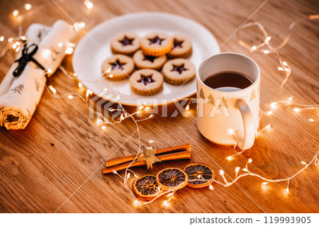 Christmas cookies background. Linzer candy with tea on wooden table 119993905