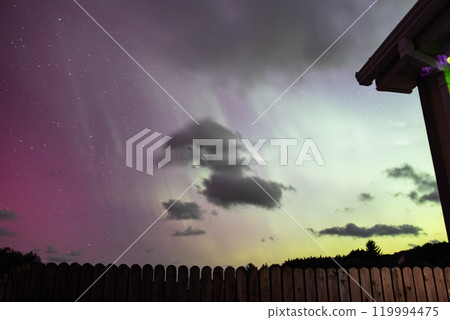 The Aurora Borealis, the northern lights, showing up above bungalow in County Donegal, Ireland 119994475