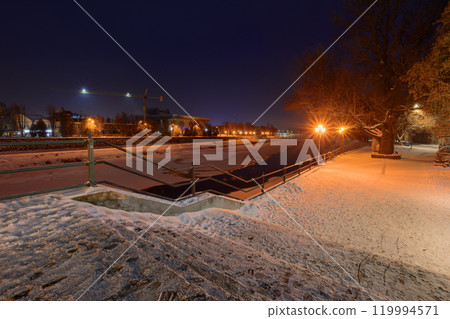 uzhhorod, ukraine - 26 DEC 2016: urban scenery with riverside at dawn. holiday season. winter holidays cityscape. light of downtown reflecting in the water. old city 119994571
