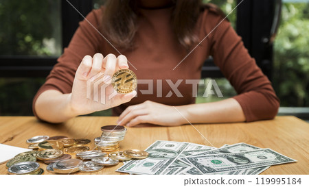 Golden Litecoin (cryptocurrency) in hand of businesswoman. New Virtual money concept. Golden Litecoin (cryptocurrency) in hand of businesswoman. New Virtual money concept. 119995184