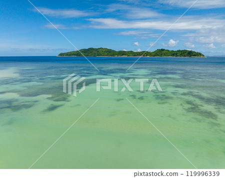 Clear turquoise water with corals and Cagbuli Island in El Nido, Palawan. Philippines. Clear turquoise water with corals and Cagbuli Island in El Nido, Palawan. Philippines. 119996339