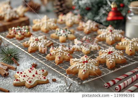 A cozy kitchen scene featuring a tray of freshly baked Christmas cookies cooling on a rack, surrounded by baking supplies, cookie cutters, and cheerful holiday decorations 119996391