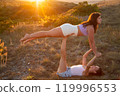 Young beautiful women doing aerial gymnastics against the backdrop of the sunset 119996553
