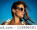 Portrait Young woman in white polka dot dress and sunglasses posing against the backdrop of the sky. Close-up 119996581