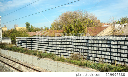 Wooden beams of different sizes. Lumber. Concept - sale of wood for construction. Piles of wooden beams lie on the ground. Concept - Buying wooden slings for building a house. Open-air lumber. High 119996888