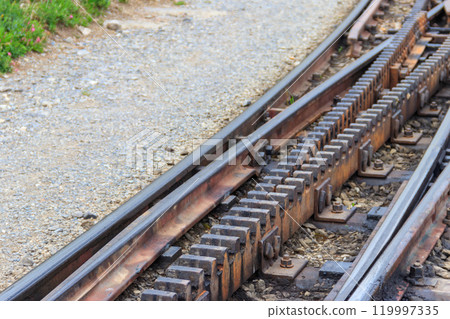 Close-up of the cogwheel railway tracks Close-up of the cogwheel railway tracks 119997335