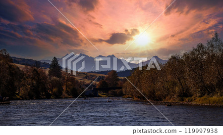 Stunning River Landscape at Sunrise with Majestic Mountains Stunning River Landscape at Sunrise with Majestic Mountains 119997938
