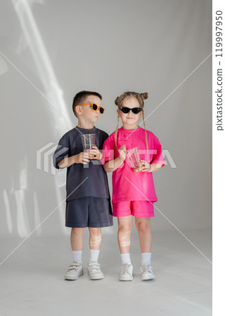 Little couple kids boy girl 4-5 years old clothes shirt dress posing have fun isolated on white background children studio portrait. People childhood lifestyle 119997950
