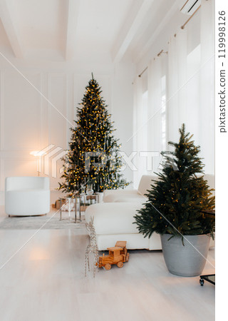 Room with Christmas decorations, white sofa adorned with lights, cozy blanket, Christmas tree decorated with ornaments, gold gift boxes, staircase, elegant and festive 119998126