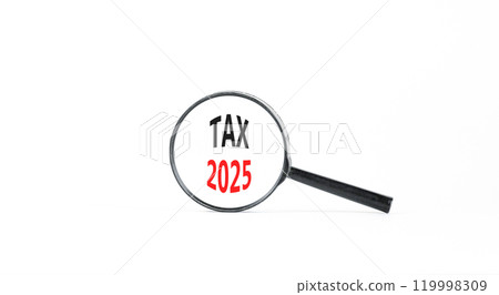 Planning tax 2025 new year symbol. Concept words Tax 2025 on beautiful white paper in magnifying glass. Beautiful white paper background. Business tax 2025 new year concept. Copy space. Planning tax 2025 new year symbol. Concept words Tax 2025 on beautiful white paper in magnifying glass. Beautiful white paper background. Business tax 2025 new year concept. Copy space. 119998309
