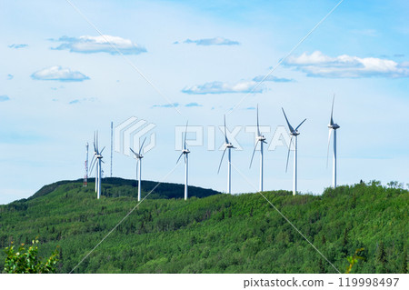 Windmills making green energy in the forest on the mountain. Windmills making green energy in the forest on the mountain. 119998497