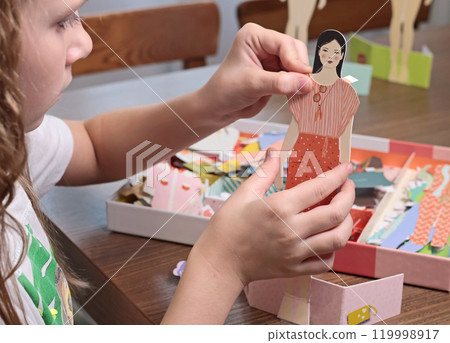 Teenage girl dresses up paper doll. Fashion and design. Pastime and lifestyle. Teenage girl dresses up paper doll. Fashion and design. Pastime and lifestyle. 119998917