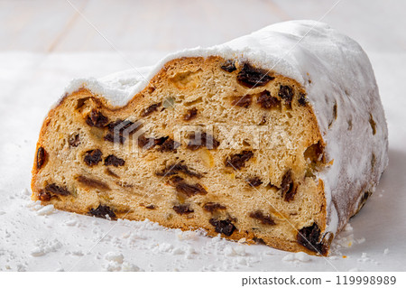 Stollen cake-like loaf cut in half closeup. 119998989