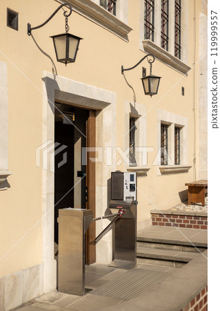 The payment turnstile for paid toilets access. A modern automatic ticket reading machine stands at museum entrance outdoors The payment turnstile for paid toilets access. A modern automatic ticket reading machine stands at museum entrance outdoors 119999557
