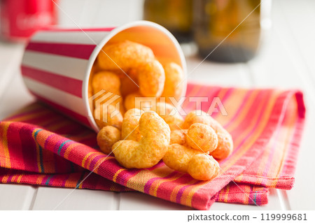 Puffed crispy Peanut flips in cup on white table. 119999681