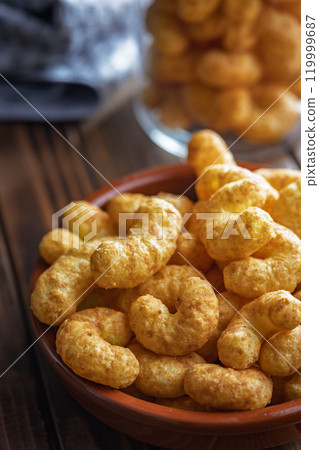 Puffed crispy Peanut flips in bowl on wooden table. Puffed crispy Peanut flips in bowl on wooden table. 119999687