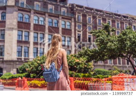 Female tourist in the central square of Mexico City, Zocalo. Cultural exploration, travel, and historic architecture concept 119999737