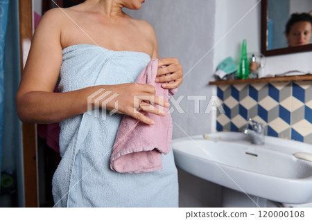 Woman drying herself with towel after shower in modern bathroom 120000108