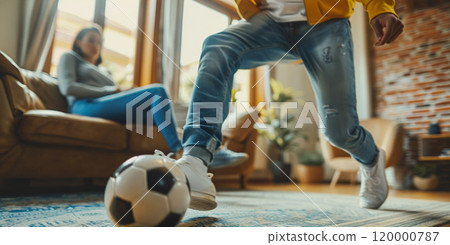 husband playing soccer with wife at home, man play football with woman at living room, person kick ball husband playing soccer with wife at home, man play football with woman at living room, person kick ball 120000787