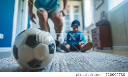 father playing soccer with son at home, man play football with kid at living room, person kick ball 120000788