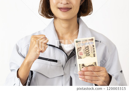 A woman in work clothes holding a stack of bills 120003315