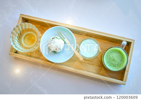 Traditional japanese tea ceremony set with matcha and wagashi on wooden tray Traditional japanese tea ceremony set with matcha and wagashi on wooden tray 120003609