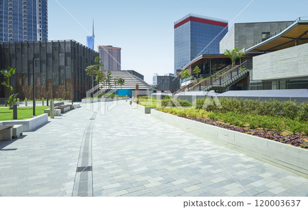 Empty modern city park with benches and skyscrapers Empty modern city park with benches and skyscrapers 120003637