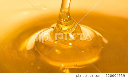 A honeycomb dripping with golden honey is illuminated by a soft warm light A honeycomb dripping with golden honey is illuminated by a soft warm light 120004639