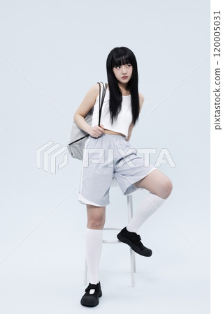 A Korean Woman in Her 20s Poses Sitting on a Chair in a Block Core fashion A Korean Woman in Her 20s Poses Sitting on a Chair in a Block Core fashion 120005031