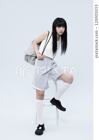 A Korean Woman in Her 20s Poses Sitting on a Chair in a Block Core fashion 120005033