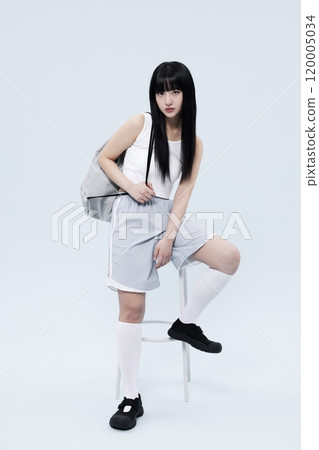 A Korean Woman in Her 20s Poses Sitting on a Chair in a Block Core fashion A Korean Woman in Her 20s Poses Sitting on a Chair in a Block Core fashion 120005034