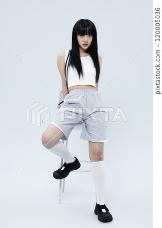 A Korean Woman in Her 20s Poses Sitting on a Chair in a Block Core fashion A Korean Woman in Her 20s Poses Sitting on a Chair in a Block Core fashion 120005036