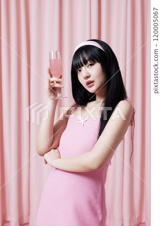 Korean woman in her 20s wearing pink dress and holding champagne cup 120005067