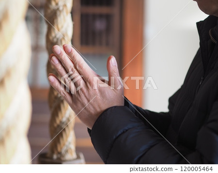 The hands and bell rope of a man praying (no face) The hands and bell rope of a man praying (no face) 120005464