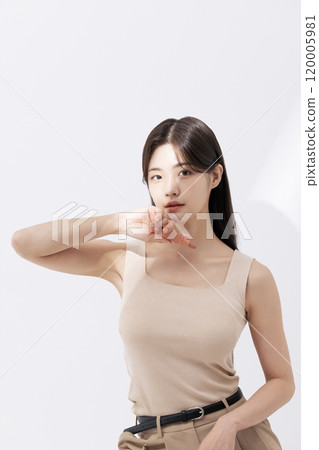 a woman holding a lipstick in the sun 120005981