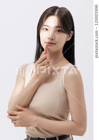 a woman holding a lipstick in the sun 120005996