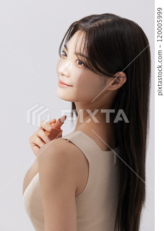 a woman holding a lipstick in the sun 120005999