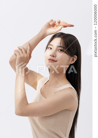 a woman holding a lipstick in the sun 120006000