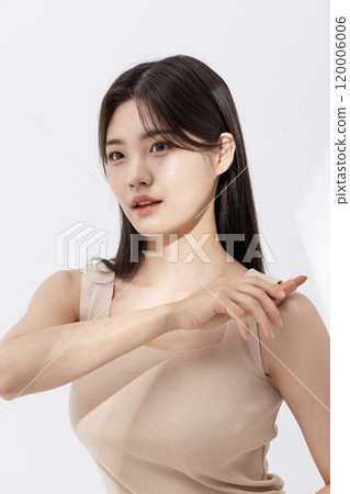 a woman holding a lipstick in the sun 120006006