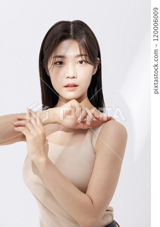 a woman holding a lipstick in the sun 120006009