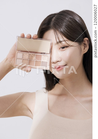 A woman posing with a shadow palette A woman posing with a shadow palette 120006027