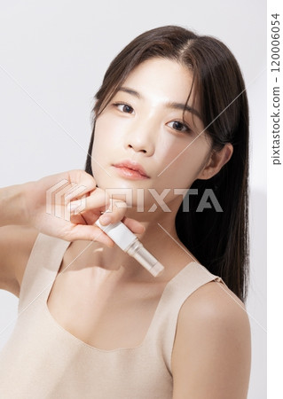 A woman posing with cosmetics A woman posing with cosmetics 120006054