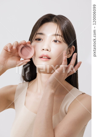 A woman posing with a blusher A woman posing with a blusher 120006099