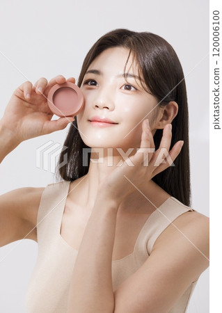 A woman posing with a blusher A woman posing with a blusher 120006100